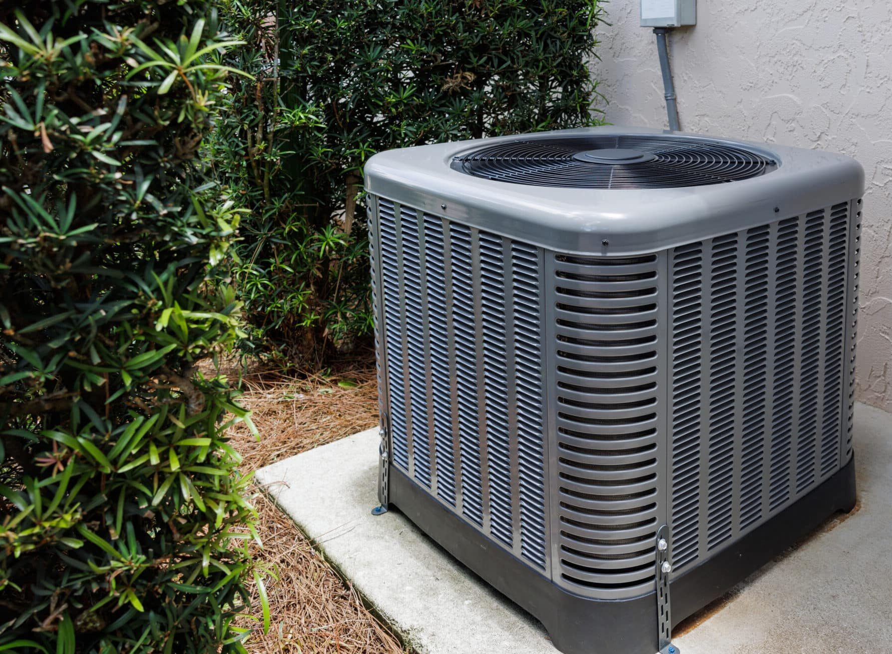 Technician installing new indoor HVAC unit in Tampa residential utility closet