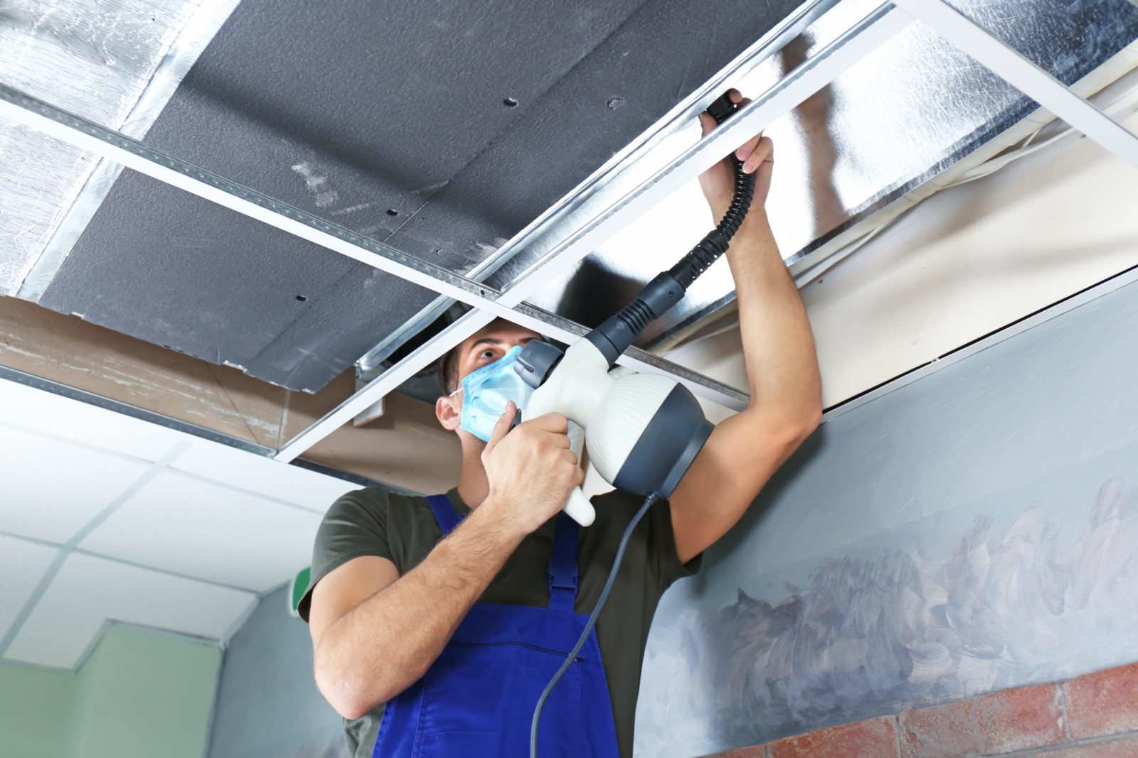 Technician cleaning dusty ceiling vent in occupied Tampa home before family moves in
