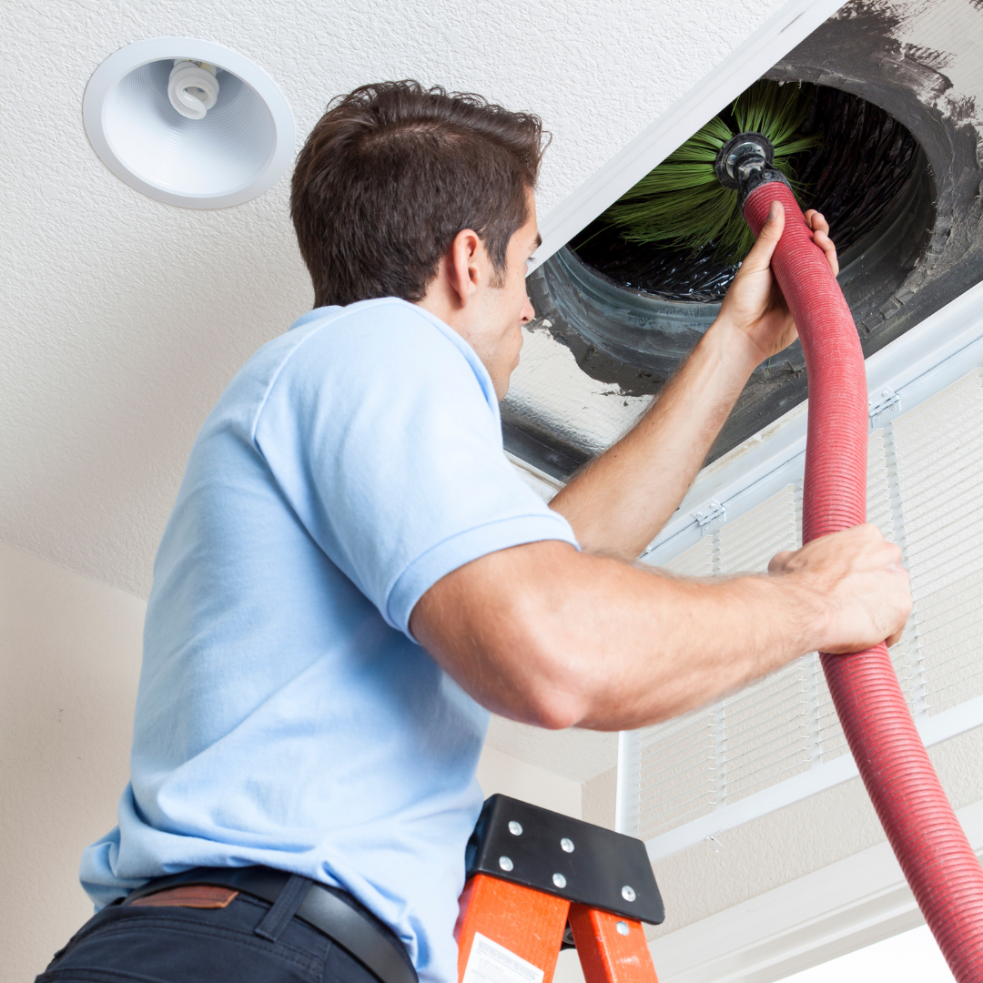 Technician cleaning dusty ceiling vent in occupied Tampa home before family moves in